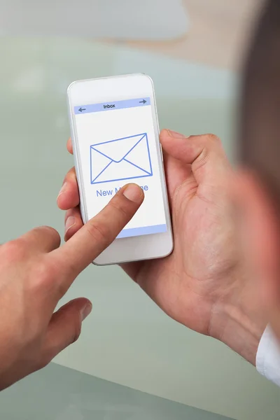 Cropped image of businessman opening message on smart phone — Stock Photo, Image