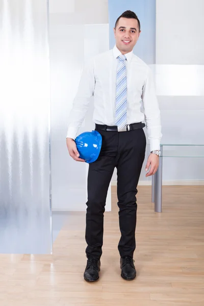 Male Architect Holding Hardhat In Office — Stock Photo, Image