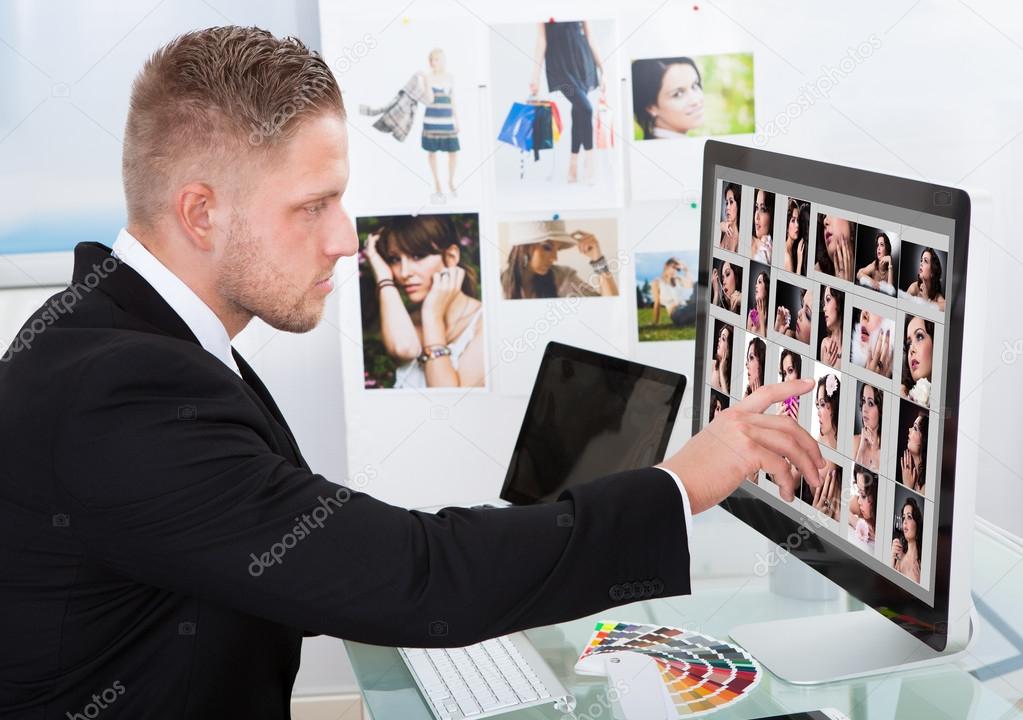Businessman editing photographs
