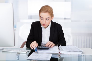 Businesswoman Calculating Bills clipart