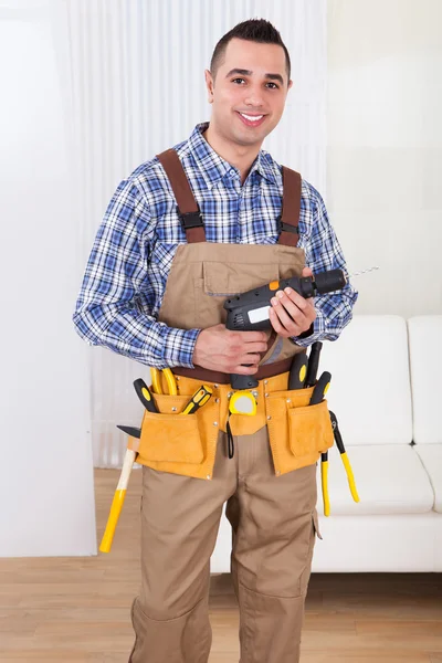 Repairman Holding Drill Machine In Living Room — Stock Photo, Image