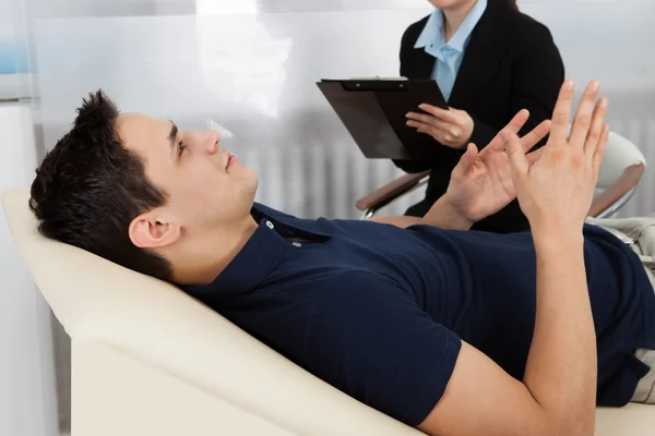 Psychologist Writing Notes While Patient Lying On Bed — Stock Photo, Image