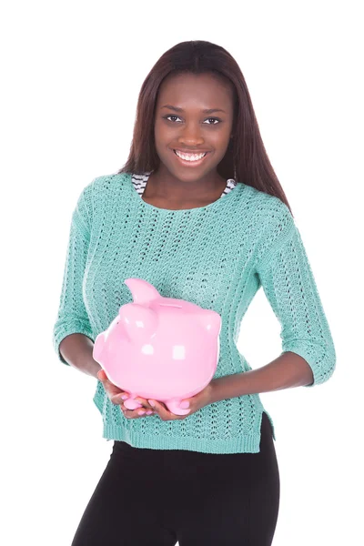 African American woman holding piggybank — Stock Photo, Image