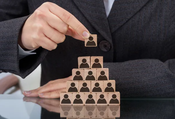 Businesswoman Stacking Wooden Team Blocks — Stock Photo, Image