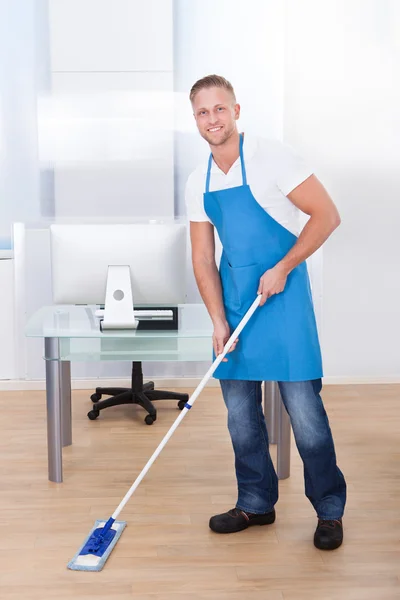 Janitor limpando o chão em um prédio de escritórios — Fotografia de Stock