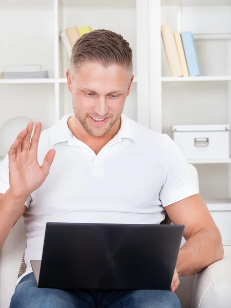 Businessman waving in pleasure to his laptop — Stock Photo, Image