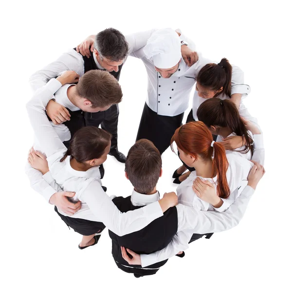 Waiters and waitresses standing in circle — Stock Photo, Image