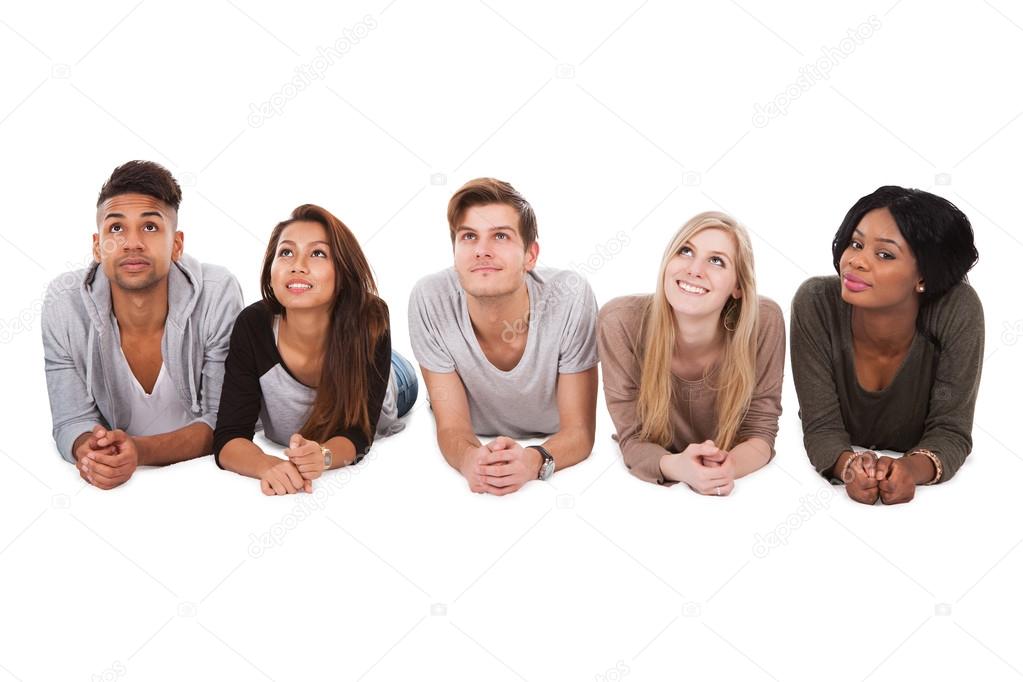 Multiethnic Students Lying Over White Background