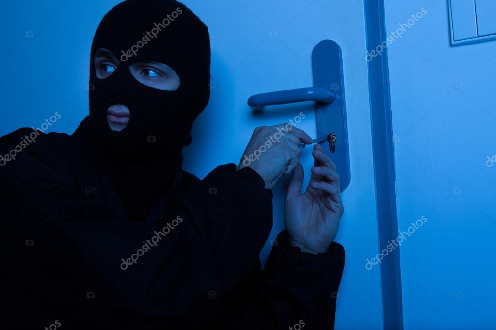 Thief Opening House Door With Tool Stock Photo C Andreypopov