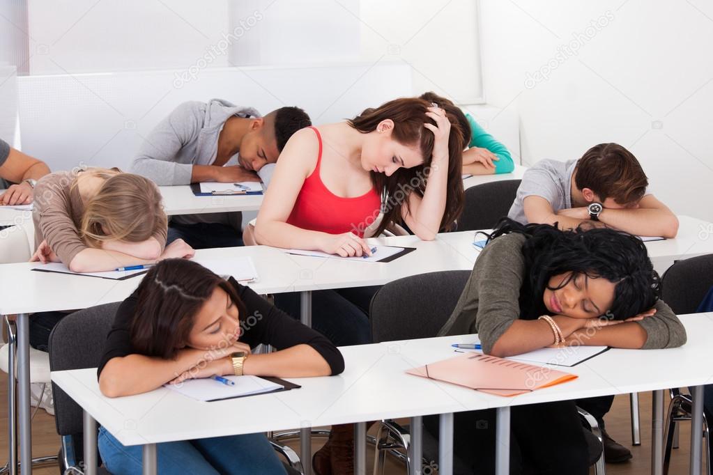 Bored Student With Classmates Sleeping At Desk