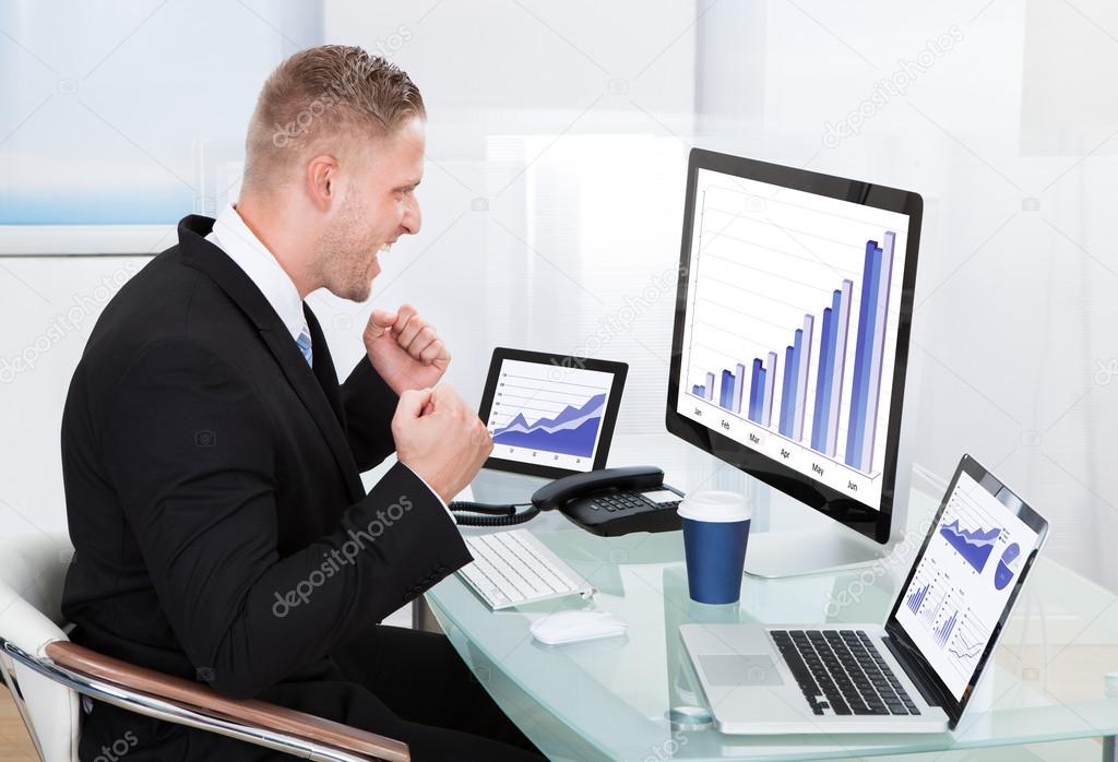 Businessman celebrating a performance graph