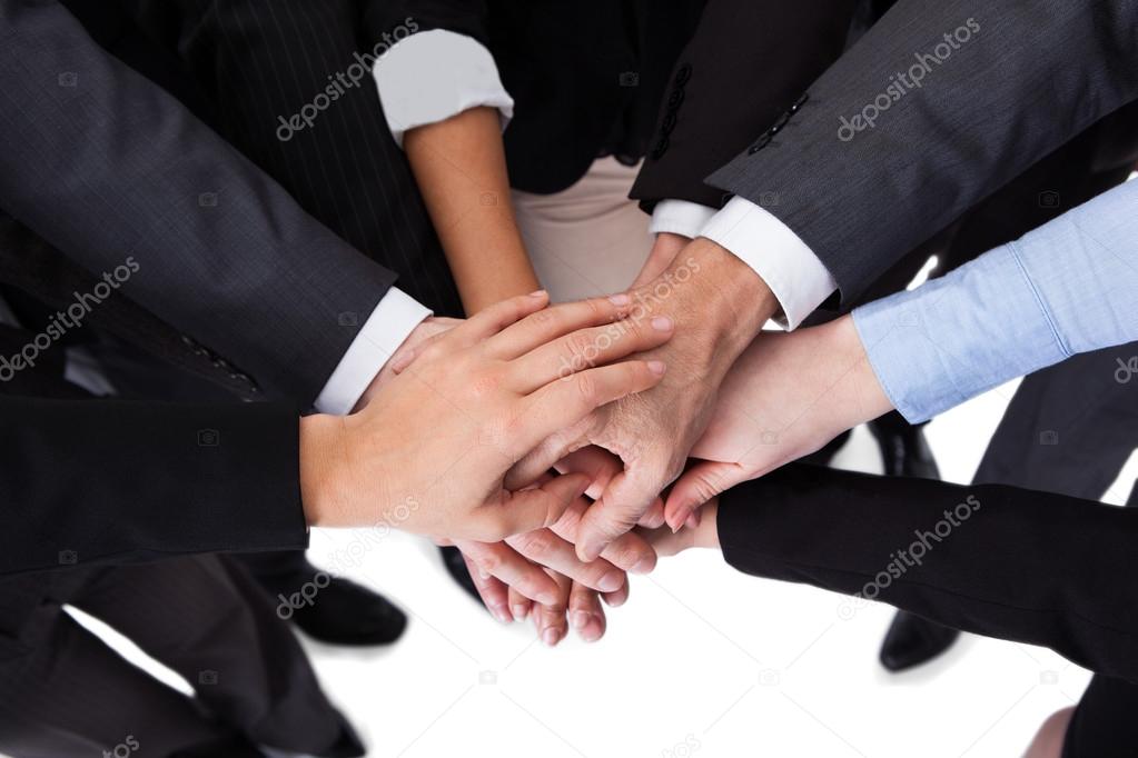 Business people stacking hands