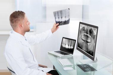 Doctor or radiologist looking at an x-ray online clipart