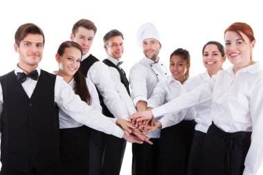 Waiters and waitresses stacking hands clipart