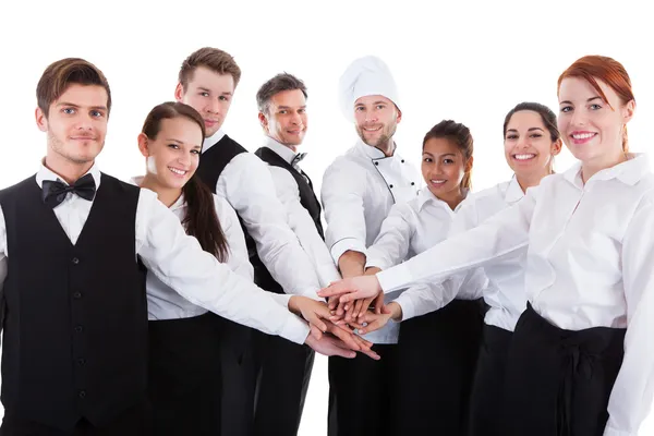 Waiters and waitresses stacking hands — Stock Photo, Image
