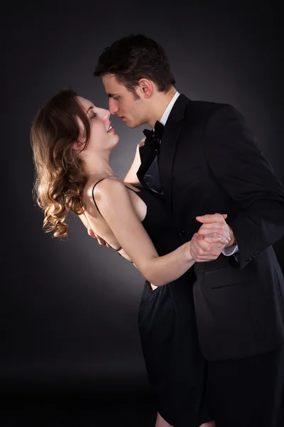 Elegant Couple Dancing Over Black Background — Stock Photo, Image