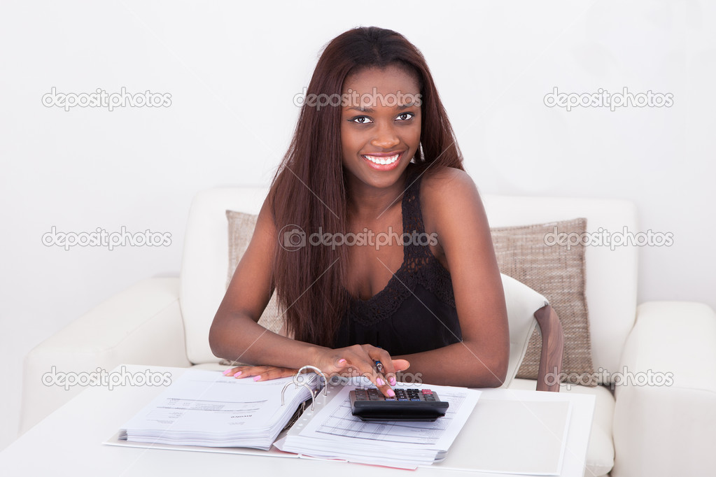 Woman Calculating Finance At Home