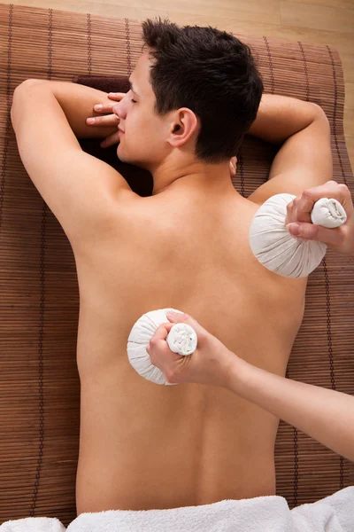 Young Man Receiving Massage With Stamps In Spa — Stock Photo, Image