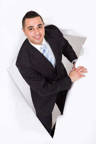 Businessman Emerging Through White Wall — Stock Photo, Image