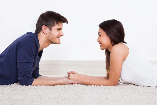 Loving Young Couple Lying On Rug — Stock Photo, Image