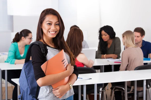 Portrait of confident female college student carrying backpack — Stock Photo, Image