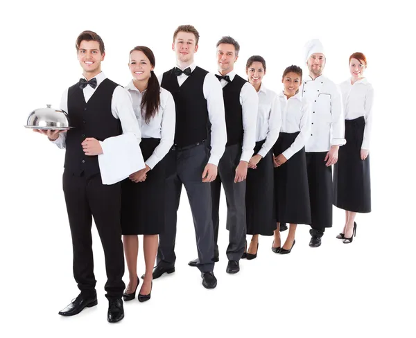 Large group of waiters and waitresses standing in row — Stock Photo, Image