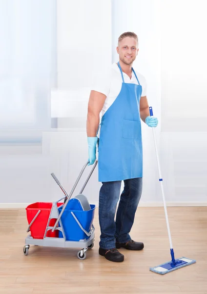 Janitor cleaning wooden floors — Stock Photo, Image