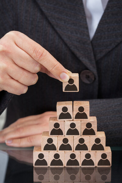 Businesswoman Stacking Wooden Team Blocks