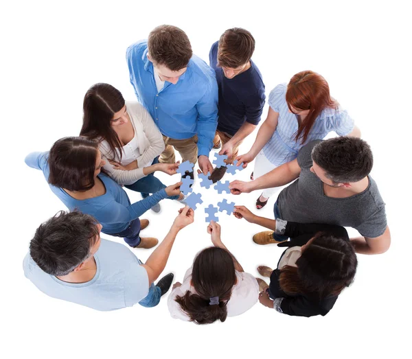 Group of people connecting puzzle pieces — Stock Photo, Image