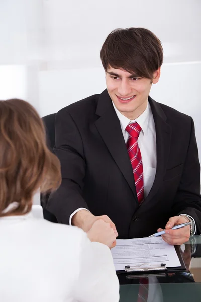 Businessman Shaking Hand With Female Candidate Stock Photo