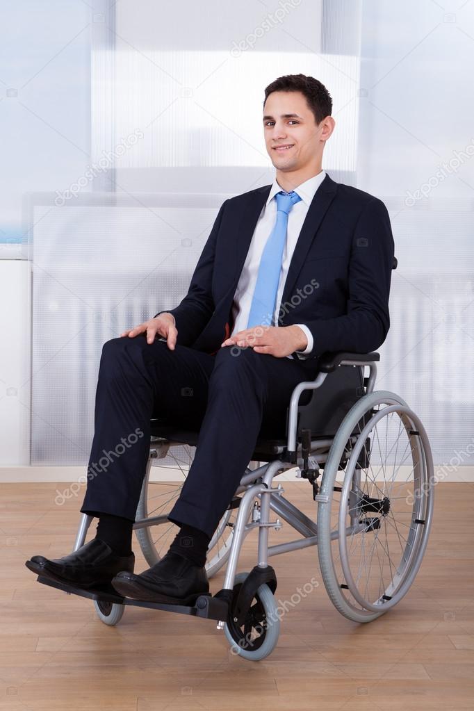 Confident Businessman Sitting On Wheelchair
