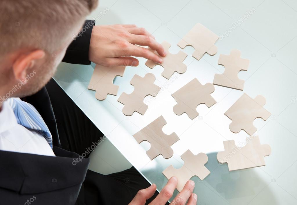Businessman with a jigsaw puzzle