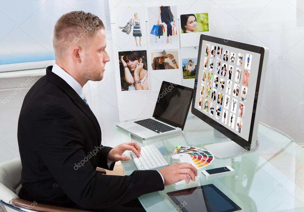 Businessman editing photographs