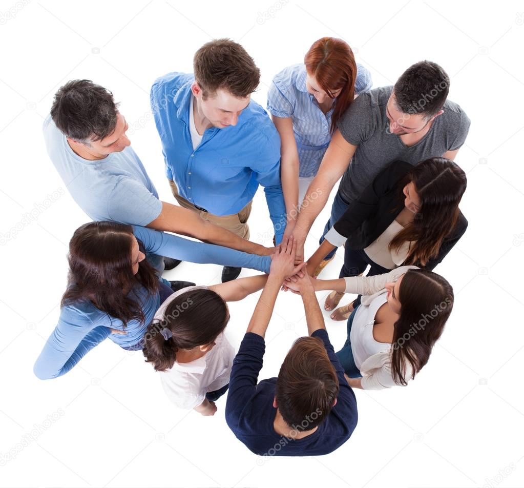 Group of people stacking hands together