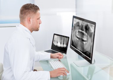 Doctor or radiologist looking at an x-ray online clipart