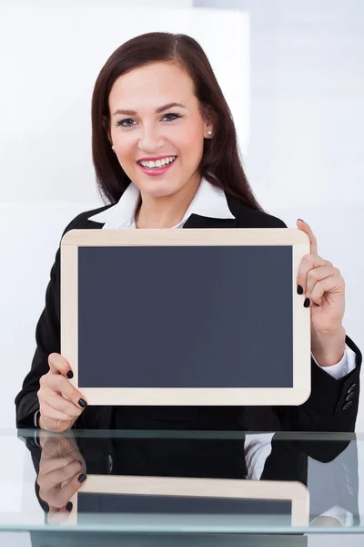 Businesswoman Holding Blank Chalkboard — Stock Photo, Image