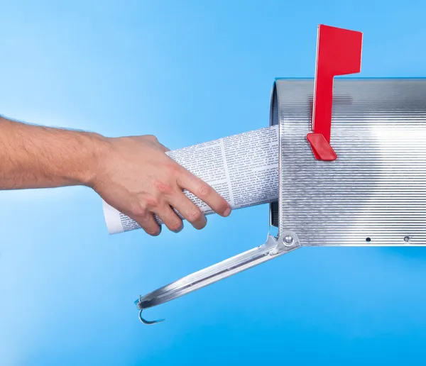 Man removing a newspaper from his mailbox — Stock Photo, Image