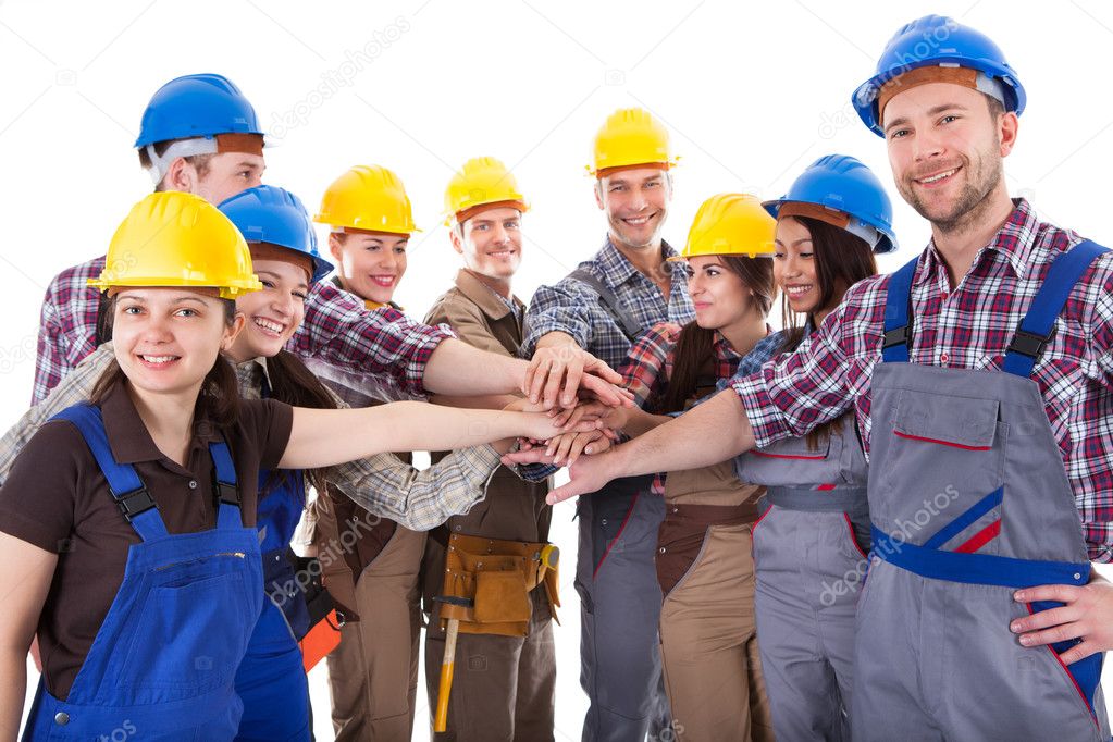 Diverse group of construction workers stacking hands Stock Photo by