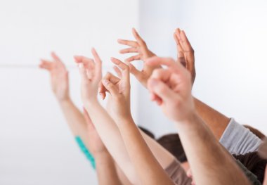 üniversite öğrencilerinin eller yükselterek satır