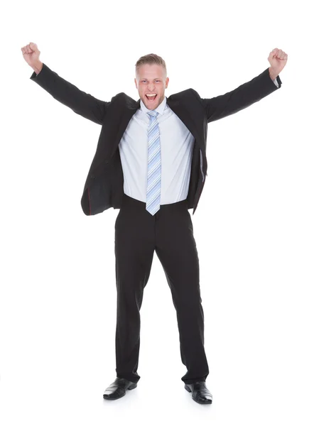 Young businessman in a suit standing cheering — Stock Photo, Image