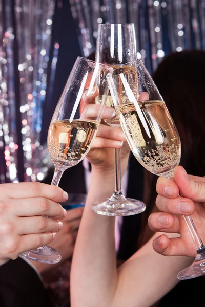 Freunde stoßen in Nachtclub mit Champagner an — Stockfoto