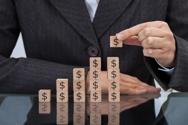 Businesswoman Stacking Dollar Blocks — Stock Photo, Image