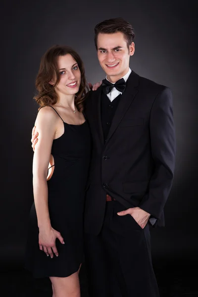 Elegant Couple Standing Over Black Background — Stock Photo, Image