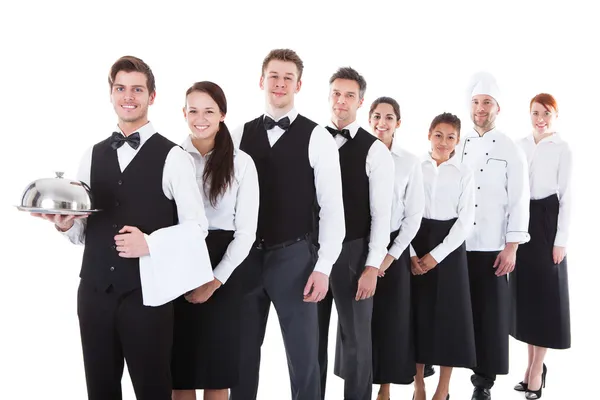 Large group of waiters and waitresses standing in row — Stock Photo, Image