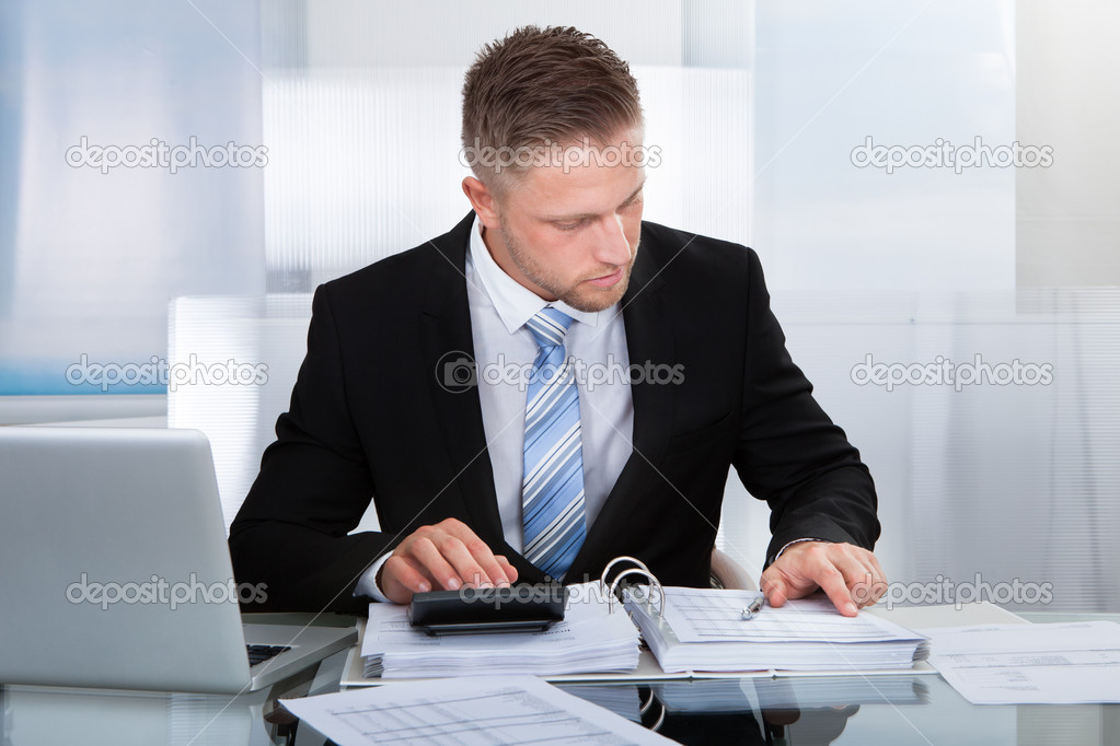 Hardworking businessman analyzing a report