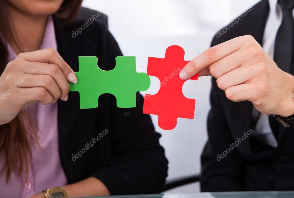 Hands Joining Puzzle Pieces