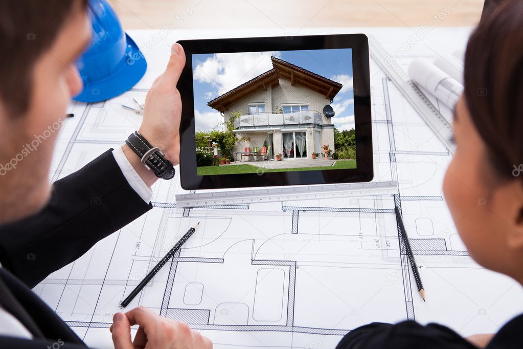 Architects With Digital Tablet Looking At House