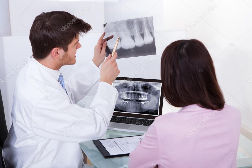 Dentist Explaining Dental Xray To Patient