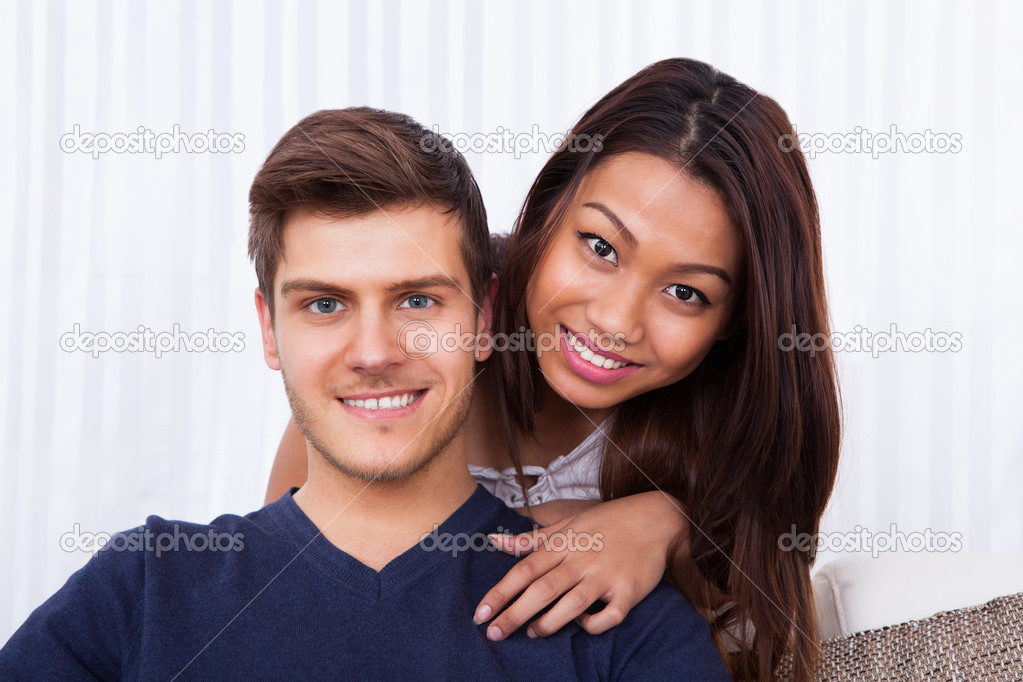 Smiling Young Couple At Home