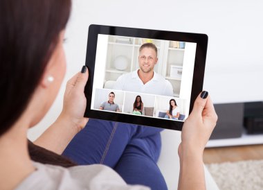 Young Woman Using Tablet For Videochatting clipart
